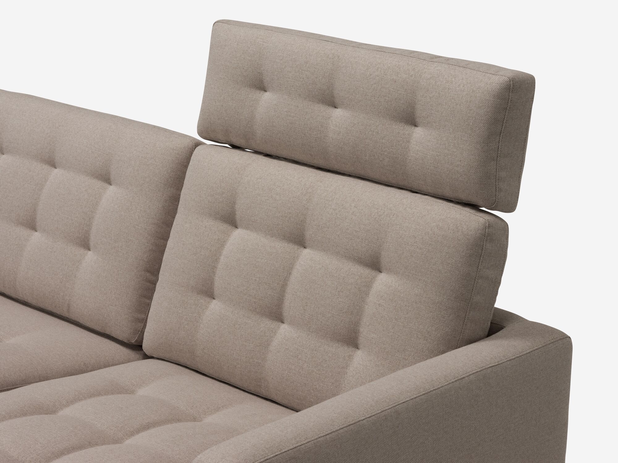 Beige tufted mid century sectional sofa headrest detail view